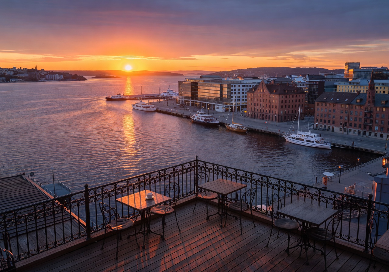 Sunset view over Oslo's Aker Brygge harbour from Kaffebrenneriet terrace